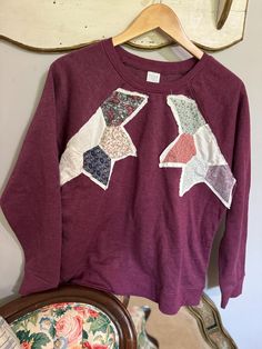 Perfect for fall or just pretending it's fall while cranking the A/C down. This purple sweatshirt has star patches pieced in the 60's near the shoulders. The ultimate in comfort and statement. Fall Cotton Patchwork Sweater, Relaxed Fit Sweatshirt With Star Print For Fall, Relaxed Fit Star Print Sweatshirt For Fall, Casual Sweatshirt With Star Patch For Fall, Casual Fall Sweatshirt With Star Patch, Fall Cotton Sweatshirt With Star Patch, Fall Cotton Sweatshirt With Star Print, Fall Star Print Cotton Sweatshirt, Fall Star Print Crew Neck Sweatshirt