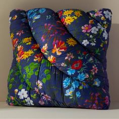 a blue pillow with colorful flowers on it