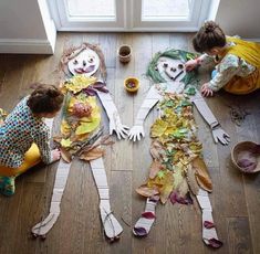 three children are making scarecrows out of newspaper strips and paper mache on the floor