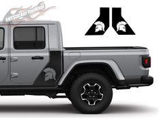 the side view of a gray jeep with spartan emblems on it's sides