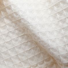 a close up view of a white blanket