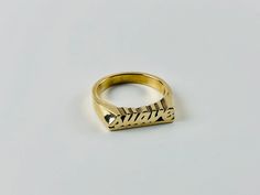 "Have a little fun and take your bling to another level with the Suave word ring. Stack it with other smaller rings. Pair it with other word rings like this one: https://www.etsy.com/listing/1063378702/rico-word-ring-rico-rich-word-ring?ref=shop_home_active_1&frs=1 word length: 16mm word height: 3 mm word width: 4 mm shank width: 1.5 mm This ring can be cast in brass, silver, or 14k gold plated over silver. If you are interested in solid gold please message me and we can discuss pricing. Love it Latina Rings, Jewelry Latina, Word Rings, Nameplate Ring, Latina Jewelry, Word Ring, Expensive Taste, Jewelry Words, Name Rings