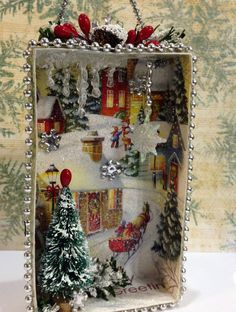 a christmas scene is shown in an altered frame with bead trimmings and ornaments