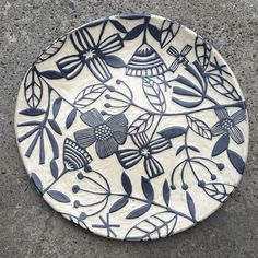 a white and blue plate sitting on the ground