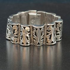 This vintage Taxco sterling silver patterned link bracelet is stunning. This bracelet is very detailed and finely crafted with a beautiful open work pattern. This piece is gorgeous on and would brighten any outfit!Vintage BraceletSterling SilverTaxcoSterling SilverDimensions: 7 1/2" long by 1" widePlease read our shop policies prior to purchase. Thanks for looking and contact us with any questions. Classic Formal Cuff Bracelet With Intricate Design, Classic Intricate Cuff Bracelet For Formal Occasions, Vintage White Gold Bracelets With Intricate Design, Vintage White Gold Bracelet With Intricate Design, Luxury Silver Bracelet With Intricate Design, Classic Sterling Silver Bracelet With Intricate Design For Wedding, Classic Sterling Silver Bangle With Intricate Design, Art Deco Bracelets With Intricate Design As Gift, Elegant Silver Engraved Bracelets