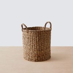 a wicker basket with books in it on a table