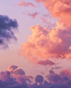 the sky is pink and purple with some clouds