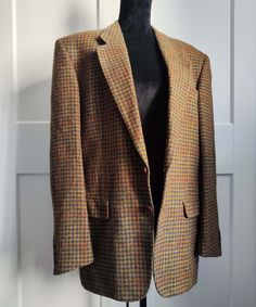 This beautiful blazer was made in Spain. The material is pure new wool. The jacket is fully lined and the lining is probably viscose. It has brown buttons for fastening on the front side and the same buttons on the sleeves for detail. It fits best women's sizes L or XL and men's sizes M or L. Check the exact measurements below: Shoulders: 48 cm / 19 in Sleeves (from armpit): 40 cm / 15.5 in Length: 76 cm / 30 in All items are measured flat. The colors of the actual items can vary slightly from the colors in the photos. The blazer is in excellent vintage condition. **Vintage items may have minor flaws due to pre-loved wear and or age. In general, we do not sell clothes with major flaws.** Fall Wool Suit With Suit Collar, Wool Suits For Fall, Wool Suit With Suit Collar For Fall, Fall Wool Suits, Wool Suits With Suit Collar For Fall, Semi-formal Wool Tweed Jacket For Fall, Wool Tweed Jacket For Business With Long Sleeves, Fall Tweed Jacket With Single Button And Suit Collar, Wool Suits With Single Button For Fall