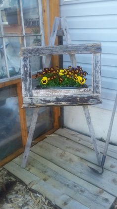 an old window frame with flowers in it