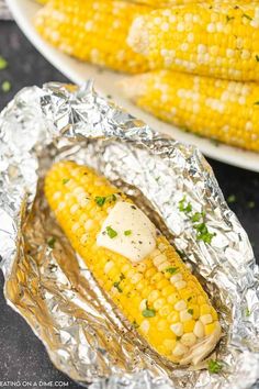 grilled corn on the cob with butter and parmesan cheese in foil