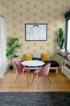 a living room filled with furniture and a painting on the wall next to a window