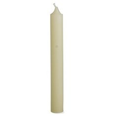 a tall white candle on a white background