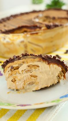 a piece of pie sitting on top of a white plate next to a cake dish