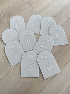 the table numbers are laid out on the floor for guests to sign in their place settings