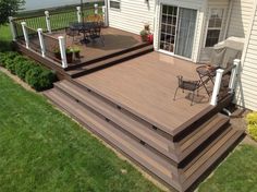 a deck with chairs and an umbrella on it