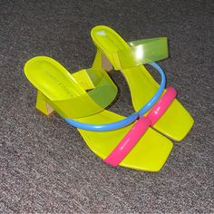 Lightly Used Neon Yellow Blue Pink Over Foot Strap Squared Toe Squared Heel Yellow Open Toe Heels With Padded Heel, Trendy Yellow Sandals With 4-inch Heel, Yellow Heels With Contrasting Heel Counter, Yellow Heels With Padded Block Heel, Yellow Block Heels With Padded Heel, Bold Yellow High Heel Shoes, Bold Yellow Open Toe Heels, Bold Yellow High Heels, Bold Yellow Summer Heels