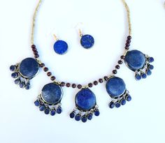 afghan lapis lazuli necklace,vintage rare necklace,tribal jewelry,boho necklace,waterfall necklace,Kuchi necklace,women long necklace,gift *you have the option of buying together or as set. Afghan Vintage rare necklace. This unique necklace is handmade with genuine Afghan lapis lazuli stone. The waterfall design and charm teardrop tassels  are inspired by kuchi jewelry. This necklace is definitely an eye-catching piece to refresh your look with any outfit. The deep blue colour of lapis lazuli is Blue Lapis Lazuli Jewelry For Festivals, Bohemian Jewelry With Natural Lapis Lazuli Stones, Handmade Lapis Lazuli Jewelry For Festivals, Traditional Round Lapis Lazuli Jewelry, Traditional Blue Brass Jewelry, Traditional Beaded Lapis Lazuli Jewelry, Traditional Lapis Lazuli Beaded Jewelry, Bohemian Lapis Lazuli Round Necklaces, Handmade Bohemian Brass Jewelry Sets