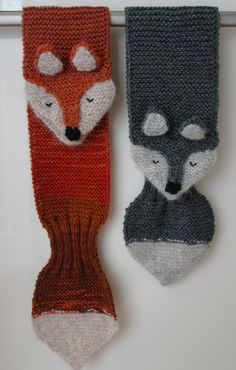 two knitted animal heads hanging on the wall