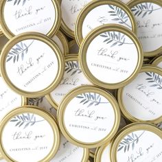 wedding favors in gold and white with greenery on the label, thank you for christmas or new year's eve