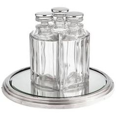 three clear glass jars on a silver plate