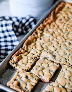 a pan filled with blueberry bars on top of a table