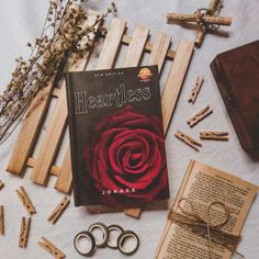 there is a book and some scissors next to it on the table with other items