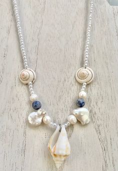 Features natural freform pearls, stone beads, and a fighting conch shell found on Fort Myers Beach. Adjustable clasp.