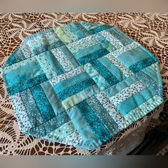 a close up of a table with a doily on top of it and a piece of cloth in the middle