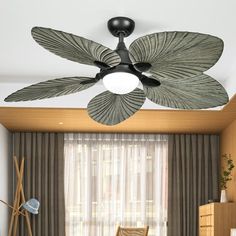 a living room with a ceiling fan in it