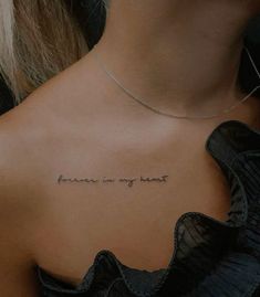 the back of a woman's neck with an inscription that says, forever is my heart