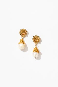 With a mesmerizing blend of contemporary flair and timeless allure, the Cleo Wrapped Pearl Drop Earrings are a true embodiment of sophistication. Each pearl is embraced by delicate gold tendrils, crafted with artisanal precision. These earrings are perfect for elevating casual-chic outfits or adding a hint of glamour to formal attire. Handmade with sustainability in mind, they offer a guilt-free indulgence in luxury, making them an essential accessory for every modern muse. Elegant Rose Gold Wire Wrapped Earrings, Elegant Wire-wrapped Yellow Gold Pearl Earrings, Elegant Wire Wrapped Earrings For Formal Occasions, Elegant Yellow Gold Wire Wrapped Pearl Earrings, Elegant Gold Wire Wrapped Jewelry, Elegant Yellow Gold Clip-on Flower Earrings, Gold Wire Wrapped Earrings For Formal Occasions, Formal Gold Wire Wrapped Earrings, Elegant Flower Drop Earrings For Celebrations