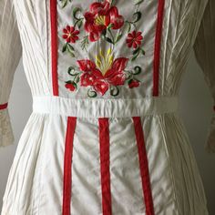 "This dress is so special. It is a vintage 60s/70s Mexican pin tucked white dress. The dress has a square neckline, that is trimmed with red ribbon and small lace ruffles, is fitted to the waist with a floral embroidered bodice that is also finished on the side with red ribbon, it has 3/4 sleeves with a flared lace cuff and red ribbon trim, The skirt is a long maxi skirt that is quite full, it has a front and back center panel with red ribbon running down the length, coming off the front panel i White Fitted Embroidered Dress For Wedding, White Bohemian Embroidered Dress With Ruffles, White Cotton Prairie Dress For Wedding, Traditional White Dress With Ruffles, White Embroidered Cottagecore Dress, Fitted White Victorian Dress, White Embroidered Maxi Dress For Daywear, Spring Folk Dress With Lace Trim, Fitted Vintage Embroidered Dress With Floral Embroidery