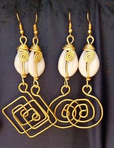 The earrings are  made with a lot of love and care from cowries and brass.   The wire is coiled to give a stunning look.  The are  beautifully designed for you, sister, mother, relative or a friend. The are light in weight and comfortable to wear. **This listing is for two pairs of earrings.** Buy multiple items pay shipping for one the rest ships free. Custom orders are welcome. For more earrings, follow the link. https://www.etsy.com/listing/697317594/african-earrings-gift-for-her-earrings?ref=related-1 **Happy shopping** Dhl shipping express Thank you. Handmade Cowrie Shell Earrings For Gift, Handmade Cowrie Shell Earrings As Gift, Gold Cowrie Shell Jewelry For Gift, Gold Spiral Jewelry For The Beach, Cowrie Shell Dangle Earrings As Gift, Handmade Spiral Earrings For Beach, Cowrie Shell Dangle Jewelry Gift, Cowrie Shell Dangle Jewelry For Gifts, Gold Cowrie Shell Earrings As Gift