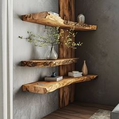 three wooden shelves with vases and flowers in them on the wall next to each other