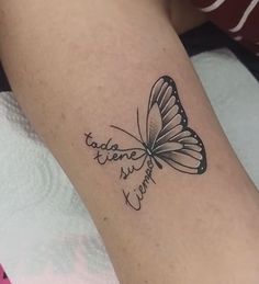 a woman's arm with a butterfly tattoo on it