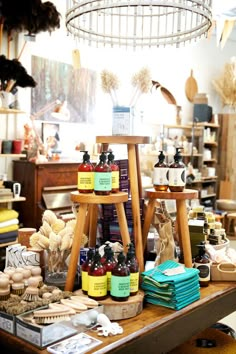 a table topped with lots of bottles and jars next to shelves filled with knick knacks