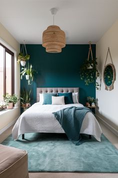 a bedroom with green walls and white bedding, potted plants on the wall