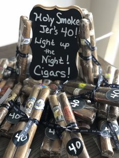 a pile of cigars sitting on top of a table next to a chalk board