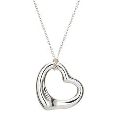 Stylish pre-owned Tiffany & Co Open Heart necklace crafted in sterling silver.    The simple and elegant design by Elsa Peretti celebrates the spirit of love. The Tiffany & Co sterling silver chain measures 16 inches and is great worn alone or layered with your fine jewelry from any era. Also included is a Tiffany & Co travel pouch.   The necklace is in very good original condition and was lightly cleaned and polished.  Particulars:  Weight: 5.6 grams  Stones:  N/A.  Size & Measurements: The necklace measures 16 inches in length. The pendant measures 22mm diameter (0.86 inches).  Metal & Hallmark: Sterling silver. The necklace is hallmarked "Ag 925" and "Tiffany & Co". The pendant is also hallmarked "Tiffany & Co" and "925" for sterling silver and "Spain". Chanel Pendant, Purple Pendant Necklace, Art Deco Pendant Necklace, Blue Pendant Necklace, White Gold Pendant Necklace, Sapphire Necklace Pendants, Open Heart Necklace, Elsa Peretti, Necklace Craft