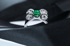 This Colombian Muzo Emerald Engagement ring's design was inspired by the Greek Columns found in Athens.  18K White gold complements this Squared cut Emerald. No oil. Measures 6.25 x 5.30mm  Carat Weigh of approx. 0.94ct  Two (2) Brilliant Round cut natural diamonds are full bezel set alongside our Emerald.  Brilliant Round Natural Diamonds: 4mm  Carat Weigh: 0.25ct each Average Color: G Average Clarity: VVS-2 Ring weighs 16.48 grams Size 7 Luxury Emerald Ring With Tension Setting, Luxury Emerald Ring With Tension Setting For Formal Occasions, Elegant Polished Emerald Open Ring, Elegant Oval Emerald Ring With Tension Setting, Luxury Sterling Silver Emerald Ring With Diamond Cut, Elegant Polished Emerald Cut Emerald Ring, Luxury Emerald Ring With Diamond Cut In Sterling Silver, Formal Emerald Rings With Tension Setting, Elegant Emerald Ring With Tension Setting