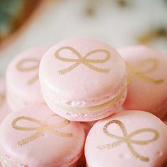 pink and gold macaroons with bows on them