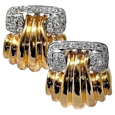 This bold and finely crafted pair of mid-20th Century 18k gold clip on earrings are comprised of white gold tops encrusted with brilliant cut diamonds, wedded to boldly fluted rich 18k yellow bottoms. A total of 54 brilliant cut diamonds having a total approximate weight of 2.35ct of overall G/H color and VS1 clarity create a stunning effect atop yellow gold dramatically designed bottoms. Total length is 1 1/4 inches and width is 1 1/8 inches. Each earring back is stamped with an Italian 18k gol Round Diamond Wedding Rings, Top Earrings, Gold Tops, Gold Clips, Denim Skirt Women, Gold Top, Diamond Set, G H, Earring Backs