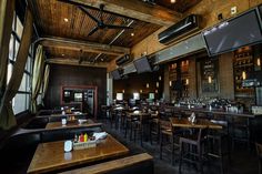 an empty restaurant with wooden tables and chairs