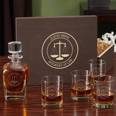 a wooden table topped with glasses filled with liquor