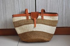 a brown and white bag sitting on top of a floor