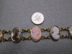 "Such an exquisite cameo bracelet! This one is rather rare, 6 beautiful genuine hand carved cameos are the focal point of this stunning piece. It is vintage 50's/60's Van Dell, new old stock, in excellent vintage condition. Well made in 12kt. gold filled to last for many years to come! It is 7 1/4\" long and 3/4\" wide. A double locking alligator clasp for security. Six different genuine shell cameos interlocking with polished gold, just gorgeous. Of course it is hallmarked Van Dell, and 12kgf." Antique Brass Collectible Bracelets, Collectible Gold Jubilee Bracelet, Vintage Antique Gold Bracelets For Formal Occasions, Antique Gold Vintage Bracelet For Formal Occasions, Victorian Gold Bracelets With Cabochon, Vintage Yellow Gold Cabochon Bracelets, Vintage Adjustable Cameo Jewelry, Vintage Hallmarked Round Chain Bracelet, Collectible Gold Bracelets With Cabochon