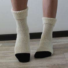 Hand knit socks Merino wool socks Hand knitted socks Cozy socks for gift Handmade socks for women Wool socks are warm, and cozy. Knitted socks can be a gift for a loved one, for friends, or loved ones! These handmade socks are sized to fit an adult woman or teenager. Wool socks Eu size 37 - 39 length - 74 cm (29.13 inches) Hand knit socks in white merino wool and black alpaca wool Care wool socks: Handmade socks can be washed by hands or in the machine. When machine-washing, always turn your knitted socks inside out before adding to your machine (this will help prevent pilling), and always go for the cool (go no hotter than 30oC), wool-wash setting. Knitted socks let it dry on a flat surface. Wool socks do not bleach. Please note that a slight color difference should be acceptable due to t Woollen Socks Designs, Cozy Handmade Socks For Stocking Stuffers, Women Wool Socks, Black Alpaca, Womens Wool Socks, Woolen Socks, Merino Wool Socks, Handmade Socks, Hand Knit Socks