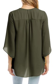 An elegant top of silky, lightweight crepe delivers elegant movement with its angled flare sleeves and fluttery asymmetrical hemline that dips low in back. 25 1/2" length (size Medium) V-neck Three-quarter sleeves Back yoke with gathering Crossover high/low hem 100% polyester Dry clean or hand wash, line dry Made in the USA of imported fabric Women's Clothing Flowy Solid Chiffon Blouse, Chic Flowy Blouse With Asymmetrical Hem, Elegant Flowy Green Blouse, Elegant Flowy Green Top, Elegant Green Flowy Top, Flowy Chiffon Blouse For Work, Elegant Chiffon Tops For Layering, Flowy Blouse For Workwear, Flowy Blouse For Work