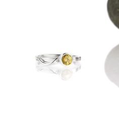 A wave of sterling silver rises up out of the base of a sparkling gemstone, and tumbles in a tiny rivulet down the side of the band. The 5mm Cascade ring is flashier than its daintier sisters, but still has a slender band designed to nestle closely with one or more accompanying rings. This sparkly citrine and sterling silver ring is handcrafted and made to order. Wear it by itself, or customize a stack of skinny bands and coordinating gemstone rings - the possibilities to mix and match are endle White Gold Sterling Silver Birthstone Ring With Tension Setting, Sterling Silver Rings With Tension Setting, Sterling Silver Topaz Birthstone Ring With Round Stone, Sterling Silver Topaz Birthstone Ring With Round Band, Sterling Silver Birthstone Topaz Ring, Sterling Silver Topaz Birthstone Ring, Sterling Silver Birthstone Ring With Tension Setting, Sterling Silver Birthstone Ring With Polished Finish, Sterling Silver Jewelry With Tension Setting In Round Band