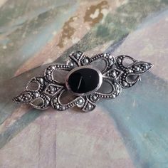 This is a vintage, sterling silver, marcasite and onyx, pin or brooch. This has tested positive for sterling. All sales are final. This measures 41 mm across. If you have a wish list or are looking for something specific, please ask. I may have exactly what you are looking for. As always please convo me with any questions or concerns regarding this item or with any international shipping questions. Unfortunately I do not accept returns or grant refunds. All shipping fees include handling fees. If you would like to combine shipping costs for more than one item, I would be happy to do so if you convo me before purchase. Purchasing my item means you have read, understood and will abide by my policies. Sorry, I do not accept trades. A bit about reserving Items. I am more than happy to reserve Vintage Black Pins As Gift, Vintage Black Pins As Gifts, Vintage Black Pins For Gift, Vintage Black Pins For Gifts, Vintage Black Brooch Lapel Pin, Vintage Black Lapel Pin As Gift, Vintage Black Lapel Pin For Gift, Black Vintage Lapel Pin For Gift, Vintage Black Brooch For Anniversary